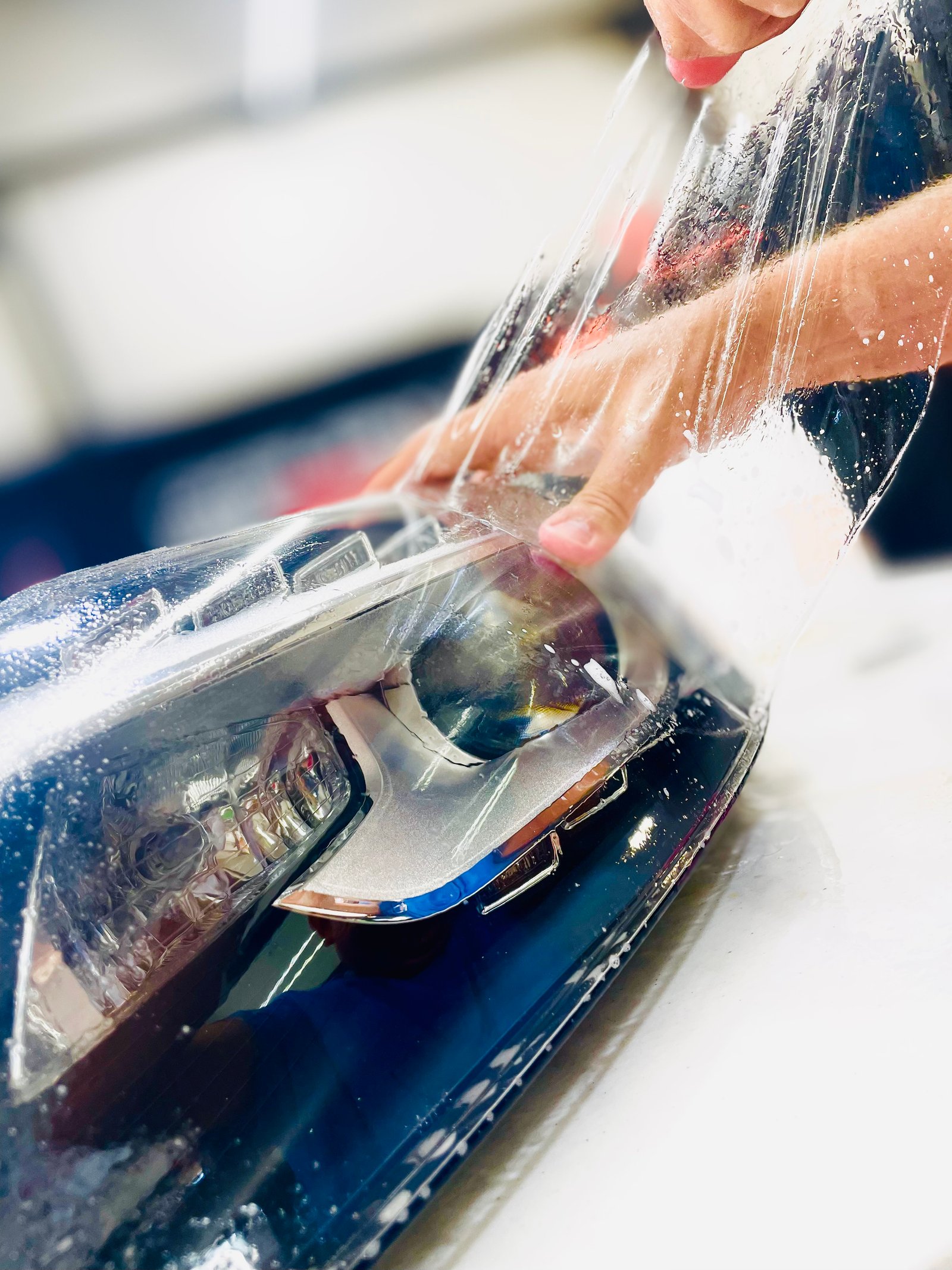 Headlight PPF installation showing crystal clear protection